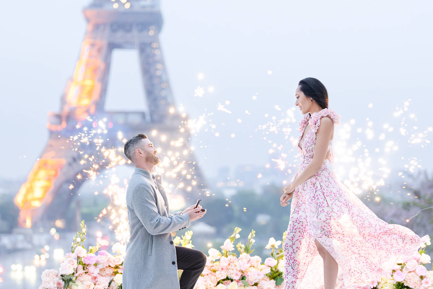 Paris proposal photographer capturing a surprise engagement at Trocadero with Eiffel Tower backdrop & fireworks.