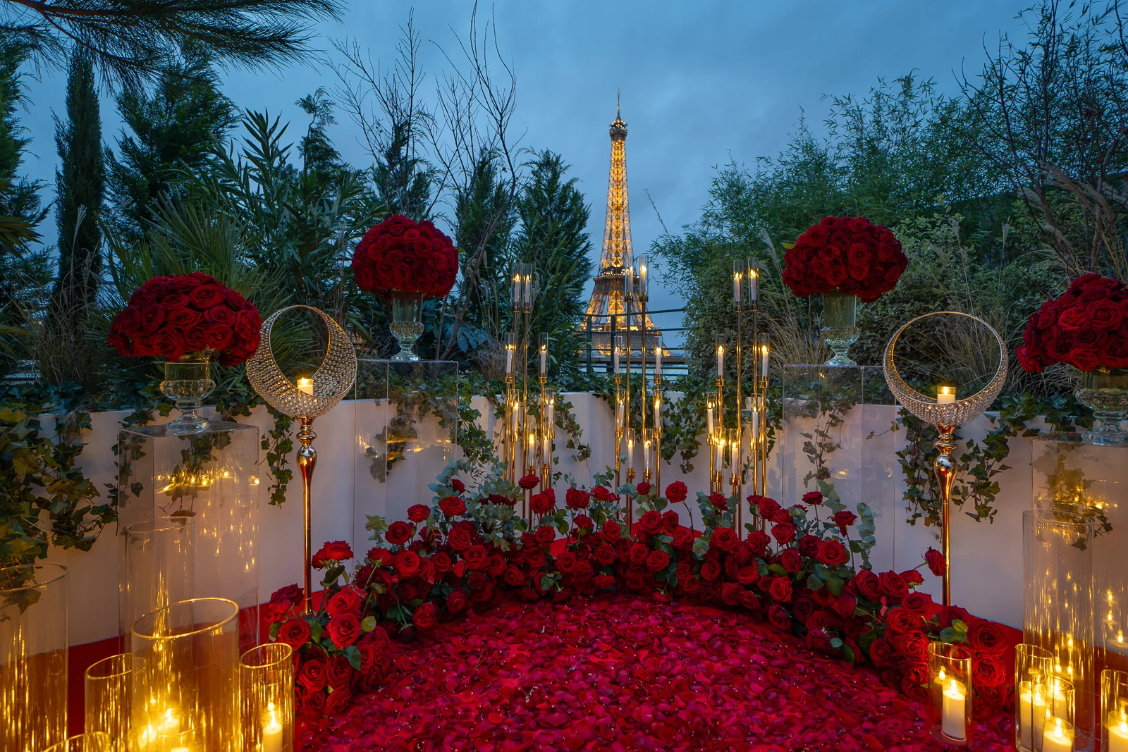 Best Picnic Spots in Paris: Private Eiffel Tower rooftop terrace proposal setup with red rose petals and candles