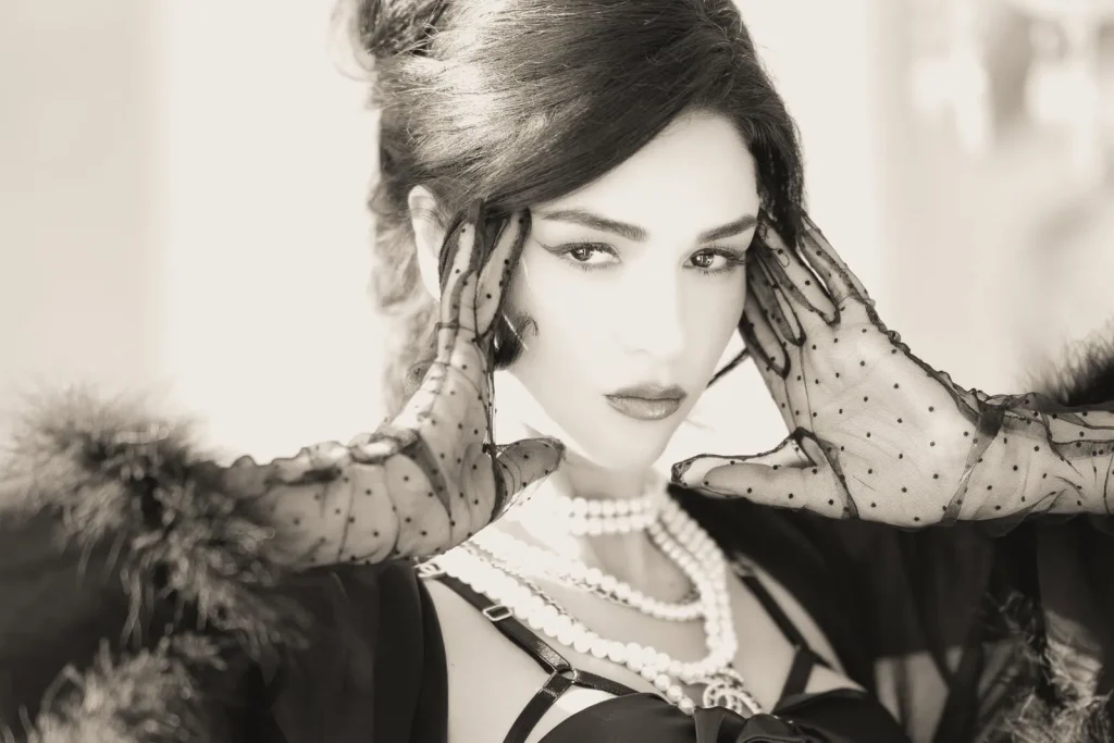 Paris boudoir photographer captures luxury noir portrait with Chanel jewelry and Agent Provocateur lingerie - professional black and white boudoir photography