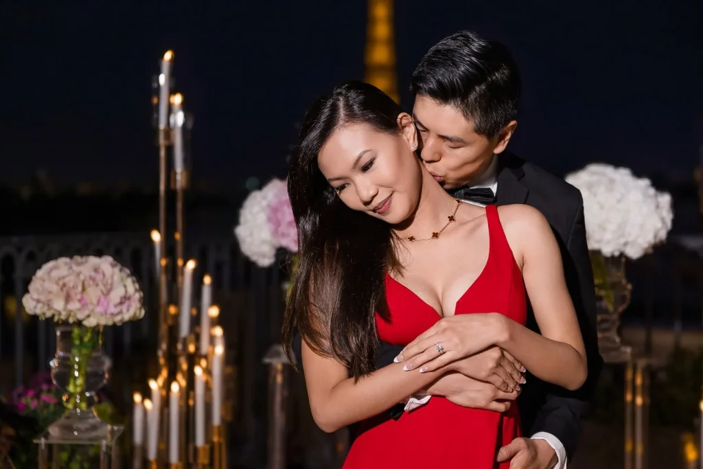 Romantic proposal at Peninsula Hotel Secret Table with luxury florals and Eiffel Tower night backdrop, Paris proposal photographer